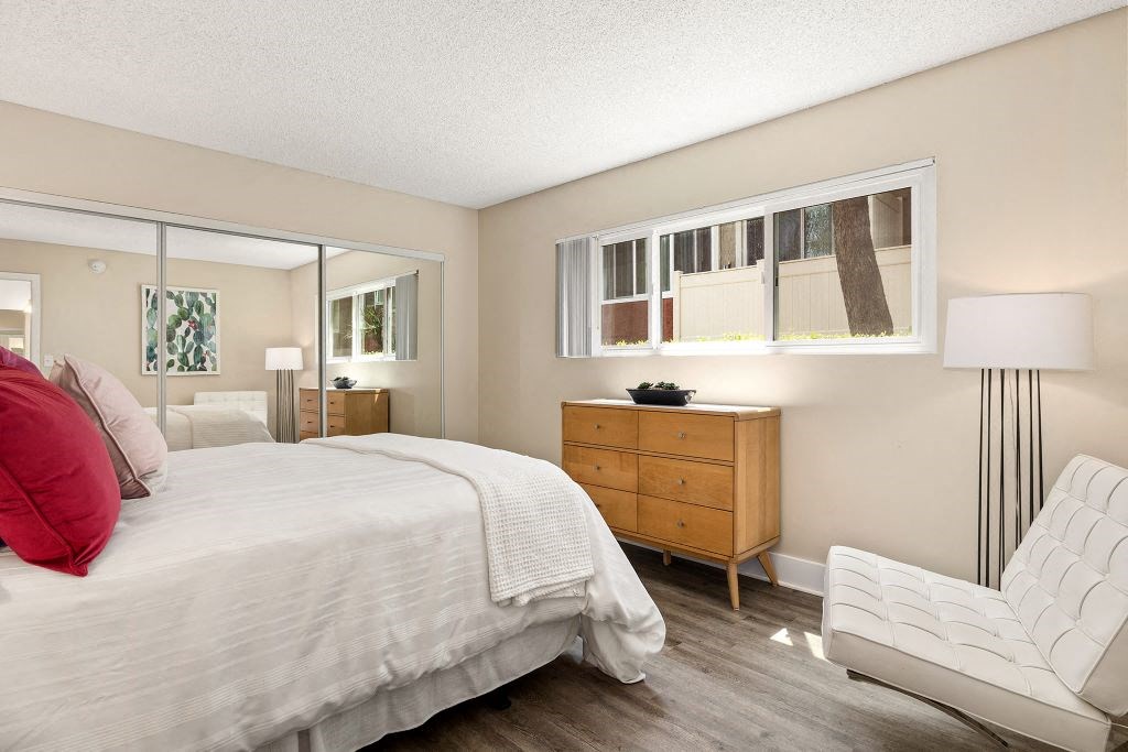 Bedroom Featuring Mirrored Sliding Closet Doors & Chic Furniture at Casa De Marina Apartments, Los Angeles, 90066