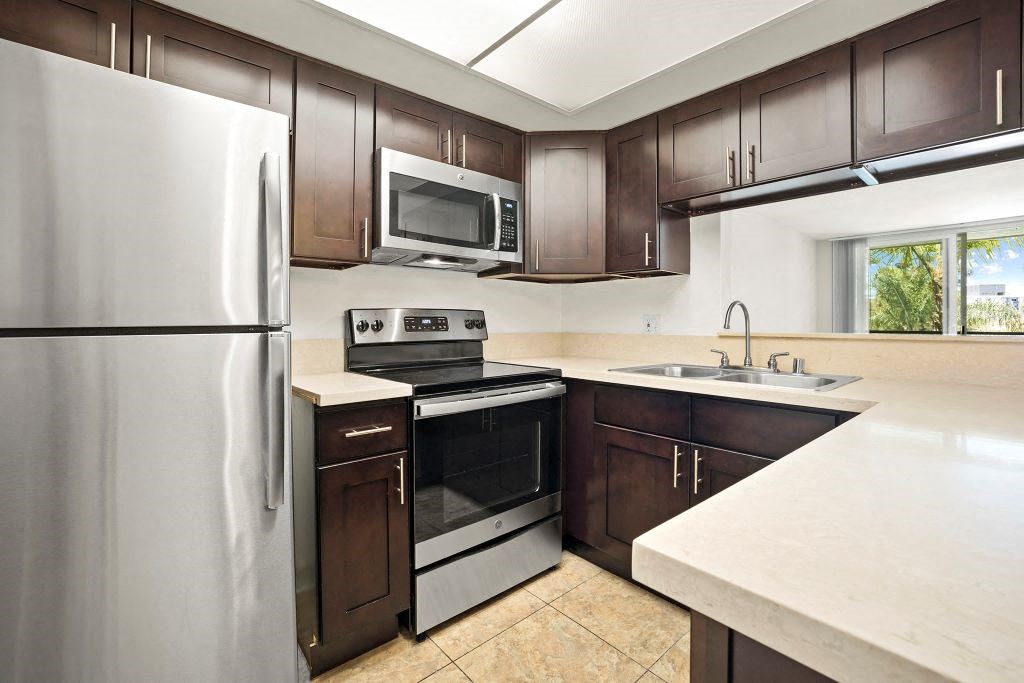 Apartments for Rent in Culver City, CA - Parkway Plaza Kitchen with stainless steel appliances, and modern dark wood cabinets