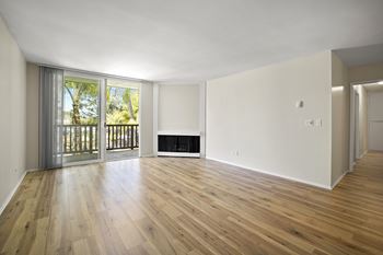 A room with wooden floors and a fireplace. at Parkway Plaza Apartments, Culver City, CA