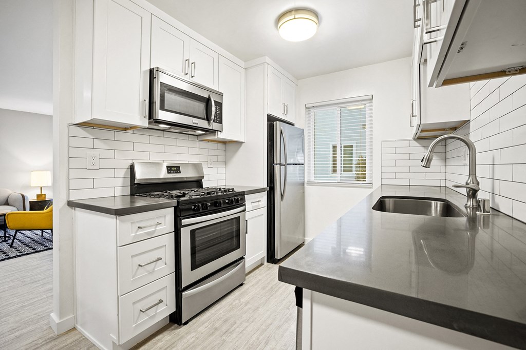 Modern Kitchen With Sleek Counters and Appliances at Kling Trio Apartments, California, 91607