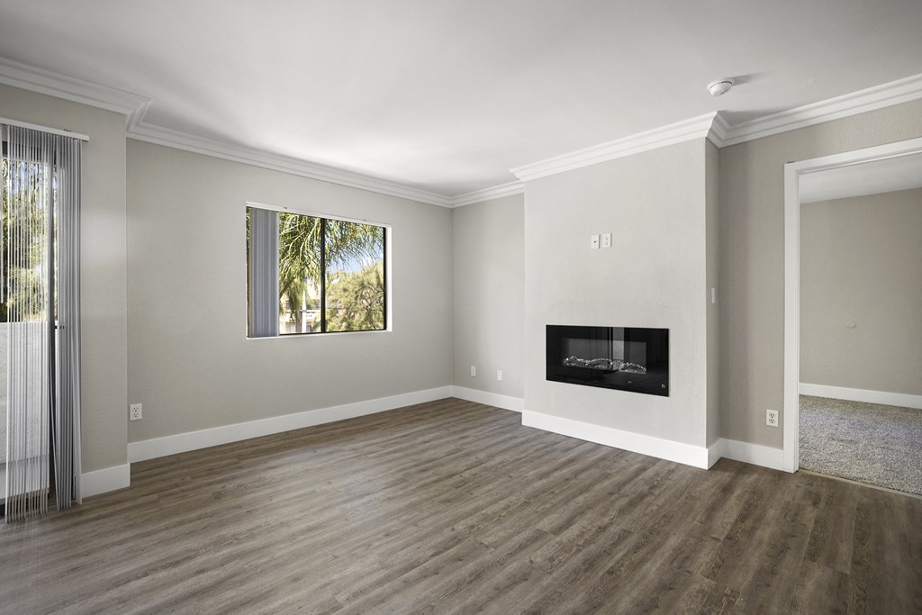 Apartments in Sherman Oaks CA - Open Space Living Room Showing Plenty of Natural Light With Hardwood Floor Featuring a Fireplace