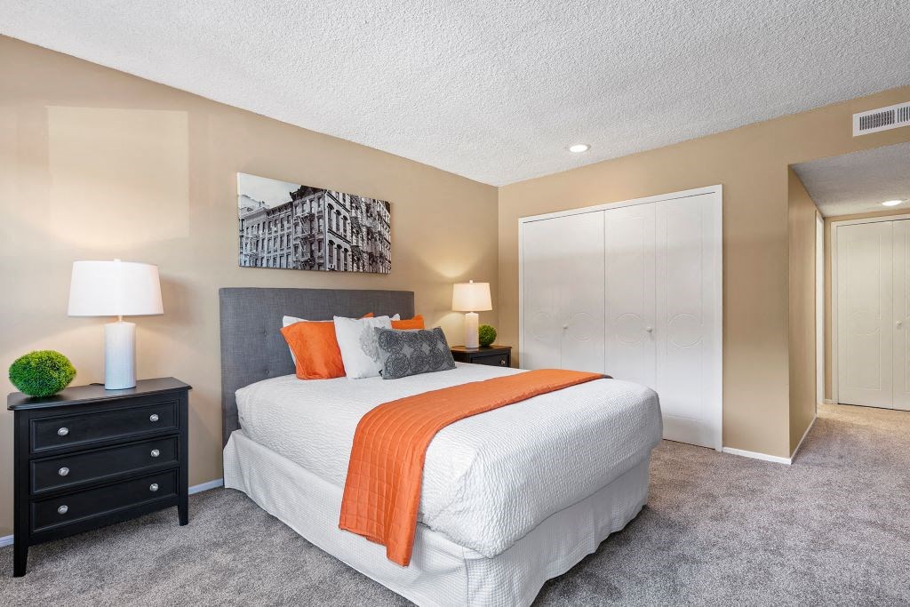 Encino Apartments - Spacious Bedroom with Plush Carpet, Neutral Colored Walls and Sliding Closet Doors.