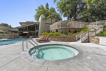 A round pool with a hot tub in the middle of it.
