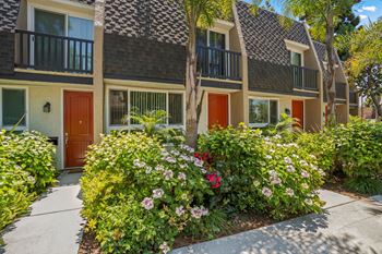 A building with a red door and a balcony. at Parkway Plaza Apartments, Culver City, 90230