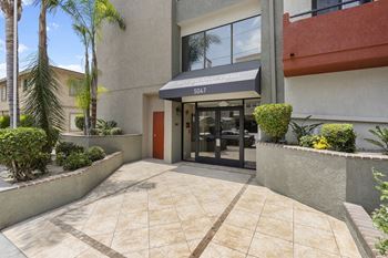 A building with a red door and a black awning at Woodland Trio Apartments, California, 91601
