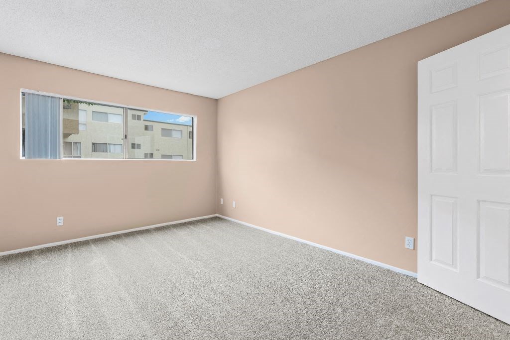 a bedroom with pink walls and a white door