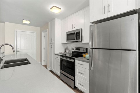 a kitchen with stainless steel appliances and white cabinets