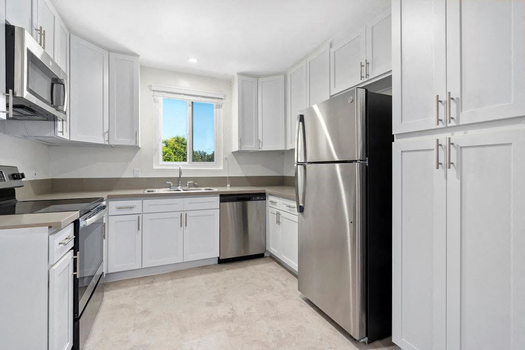 Apartments for Rent in Sherman Oaks - Krystal Terrace - Kitchen with Stainless-Steel Appliances, Natural Lighting, and White Cabinets