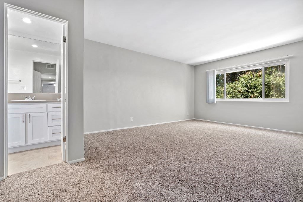 One-Bedroom Apartments in Sherman Oaks, CA - Krystal Terrace - Bedroom with Plush Carpeting, Natural Lighting, and Bathroom Access
