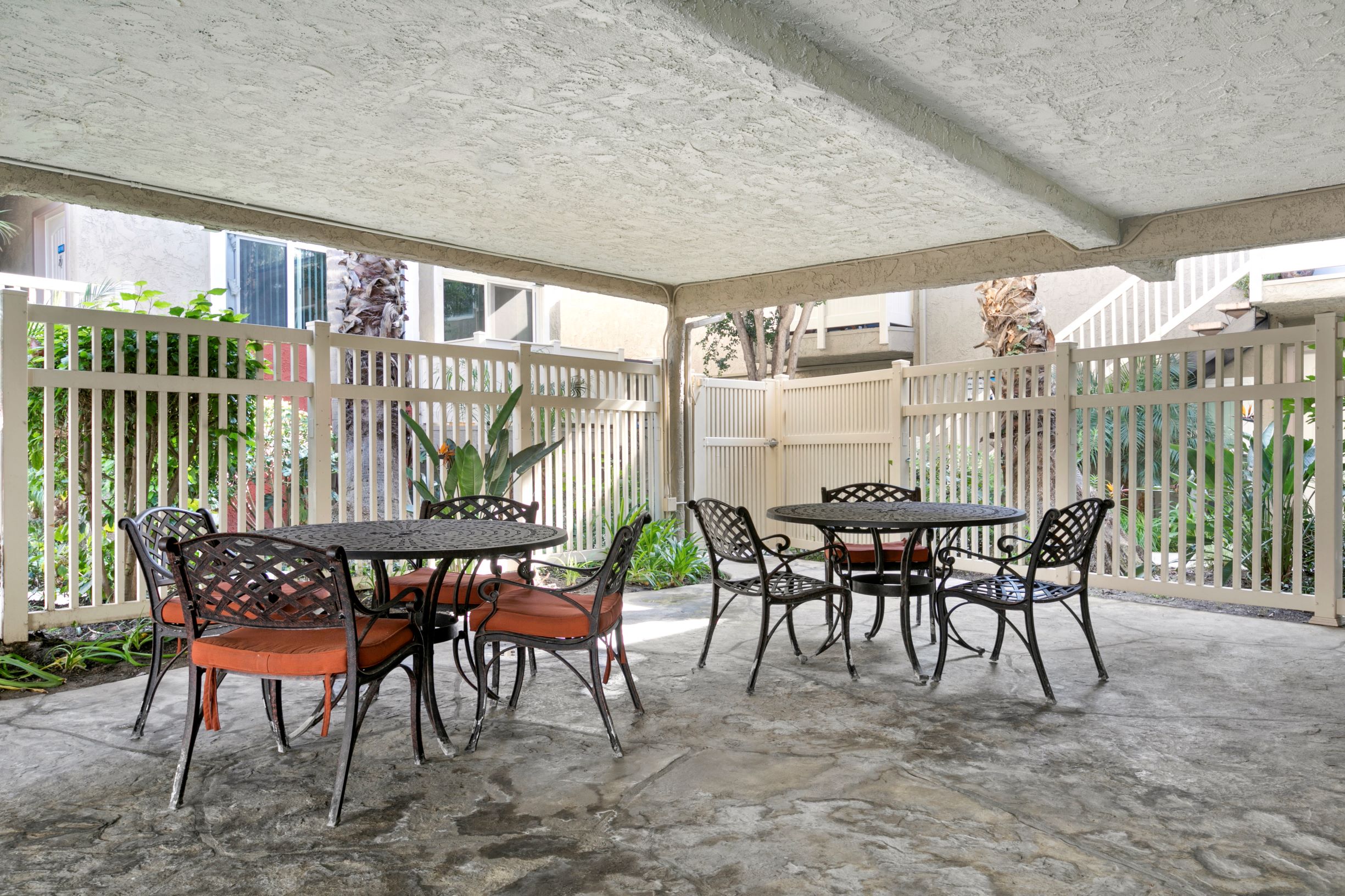 Marina Del Rey, CA Apartments - Casa De Marina - Patio Area With Two Outdoor Patio Sets with Chairs Within a Gated Area