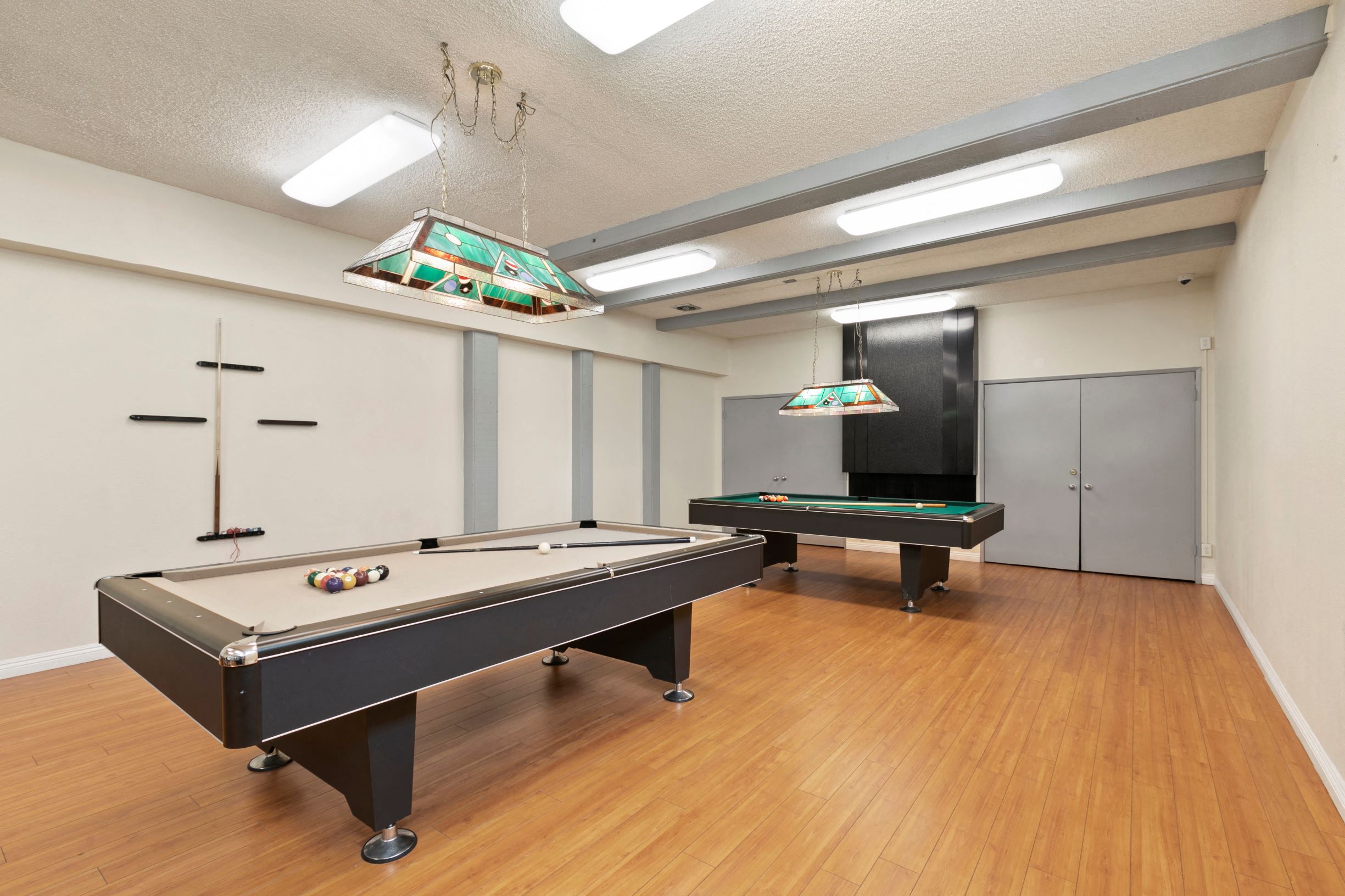 Pet-Friendly Apartments in Marina Del Rey, CA - Casa De Marina - Billiards Room With Two Billiards Tables, Equipment Shelves and Lamps over Tables
