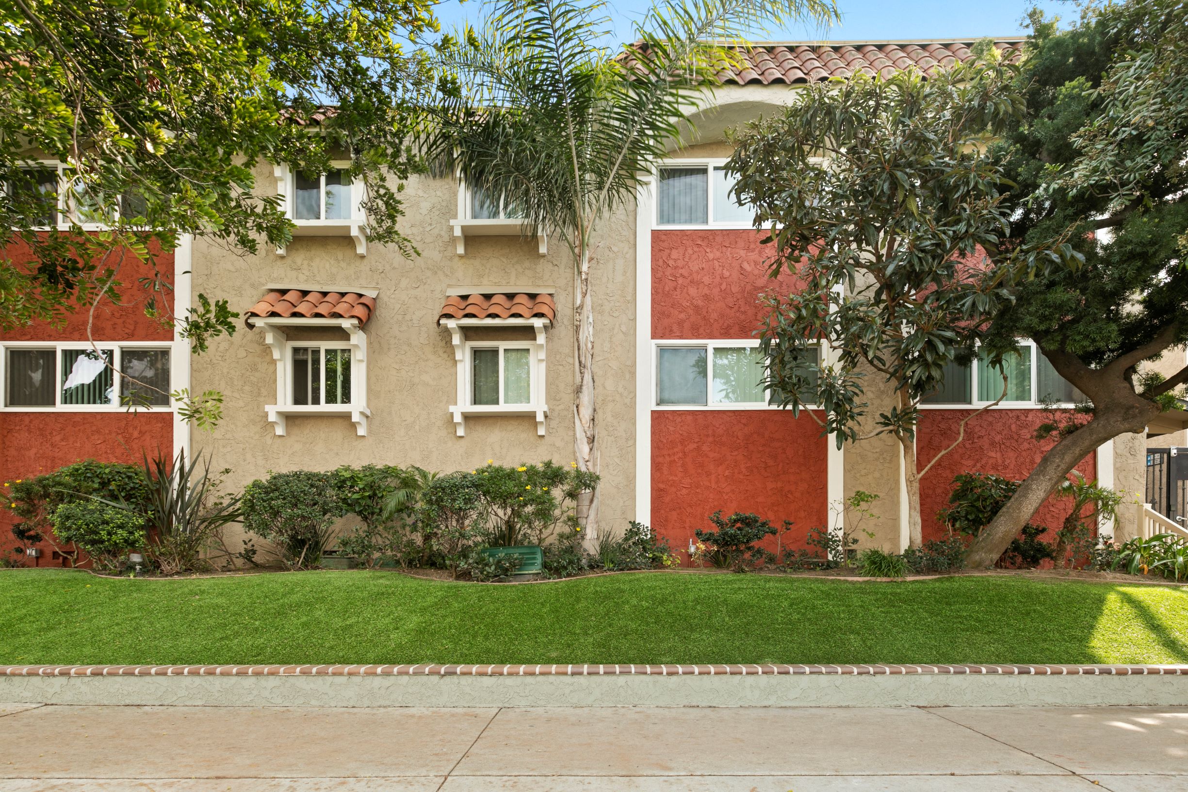 Marina Del Rey CA Apartments - Exterior View of the Property Showcasing Colorful Building and Green Landscaping