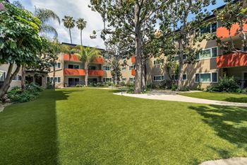 A grassy area in front of apartment buildings. at White Oak Terrace Apartments, California, 91316