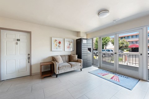 a living room with a couch and a door to a balcony