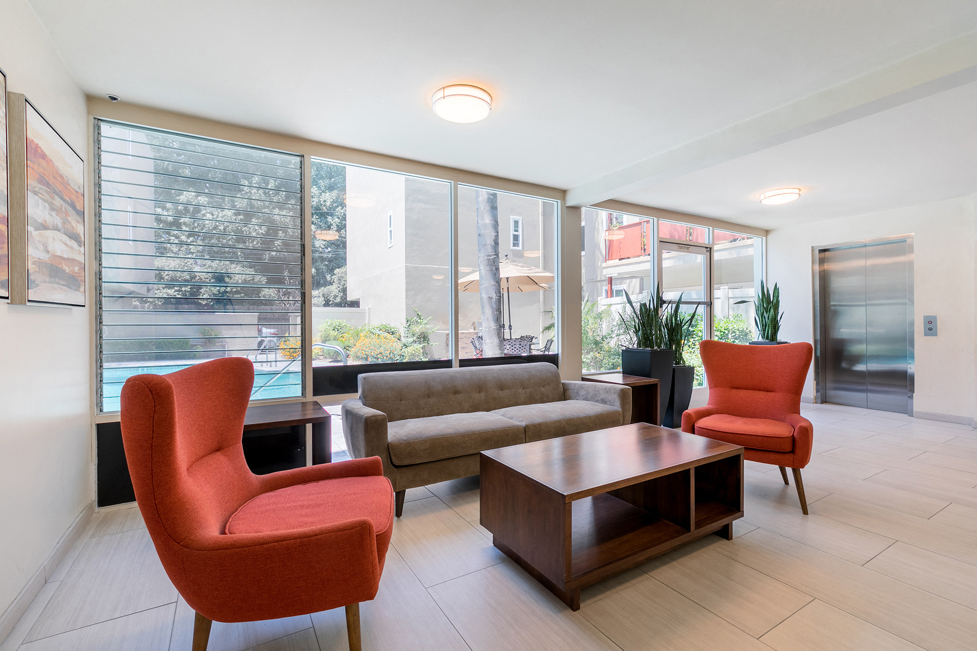 a living room with a couch and chairs and a coffee table