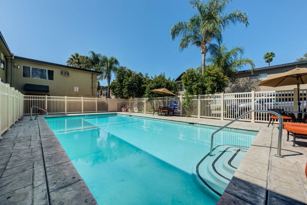 Gated Pool Surrounded by Lounge Seating at Parthenia Terrace Apartments, Canoga Park, CA, 91304