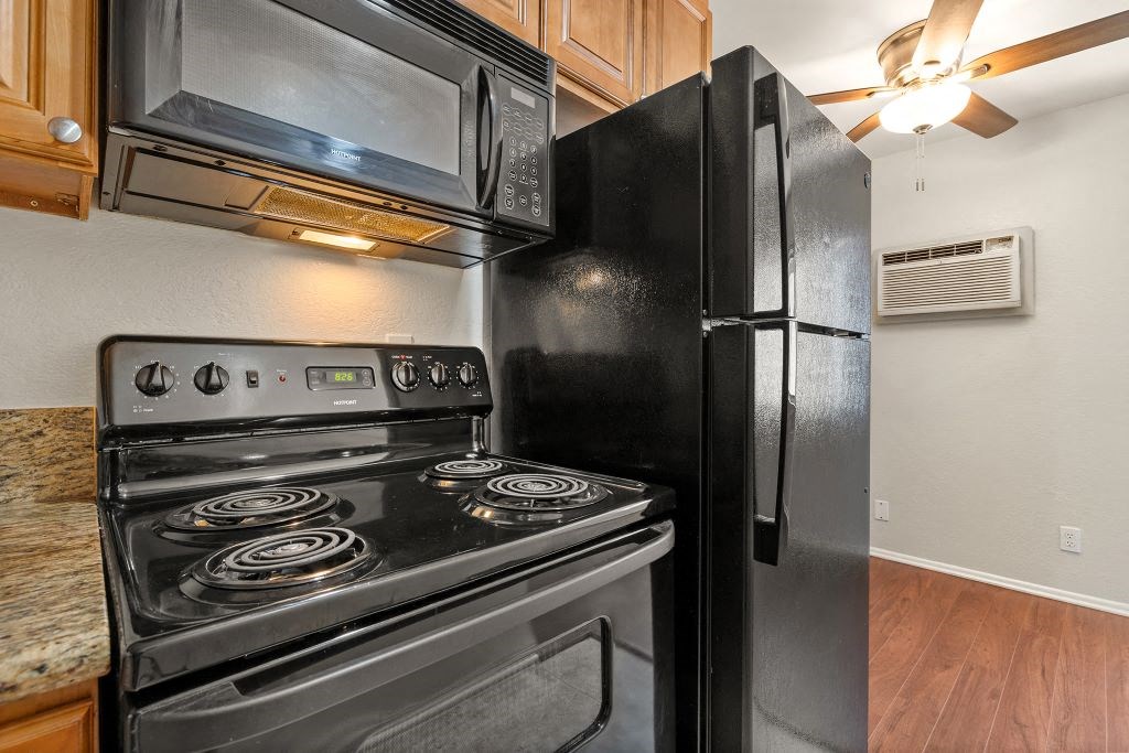 a kitchen with a stove and a refrigerator at Topanga Canyon Apartments, California, 91304