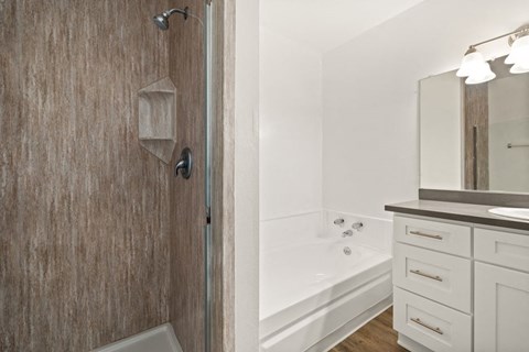 a bathroom with a shower and a sink and a bath tub at Parkway Plaza Apartments, Culver City, CA