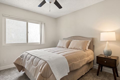 a bedroom with a bed and a ceiling fan at Parkway Plaza Apartments, California, 90230
