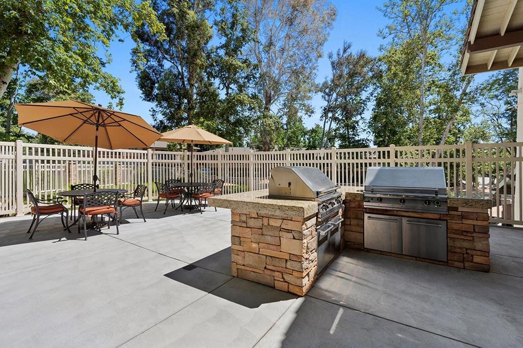 Outdoor BBQ Area with Multiple Grills and Shaded Table Seating at The Meadows at Westlake Village Apartments,California, 91361