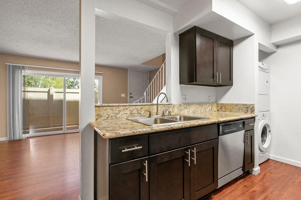 3BD/2BA Townhome Floorplan - Kitchen with Granite Countertops, New Espresso Cabinetry, Wood Flooring and Stainless Steel Appliances at The Meadows at Westlake Village, Westlake Village