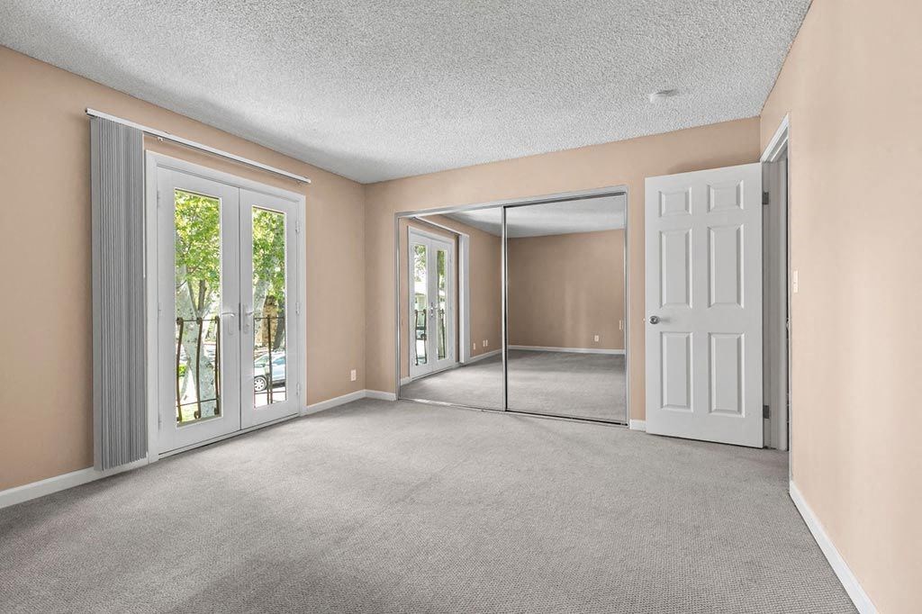 3BD/2BA Townhome Floorplan - Bedroom with Mirrored Closets and Balcony at The Meadows at Westlake Village, Westlake Village, California