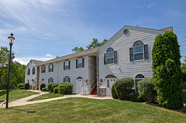 a white house with a yard and a street light