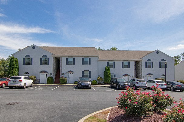 a large white building with cars parked in front of it