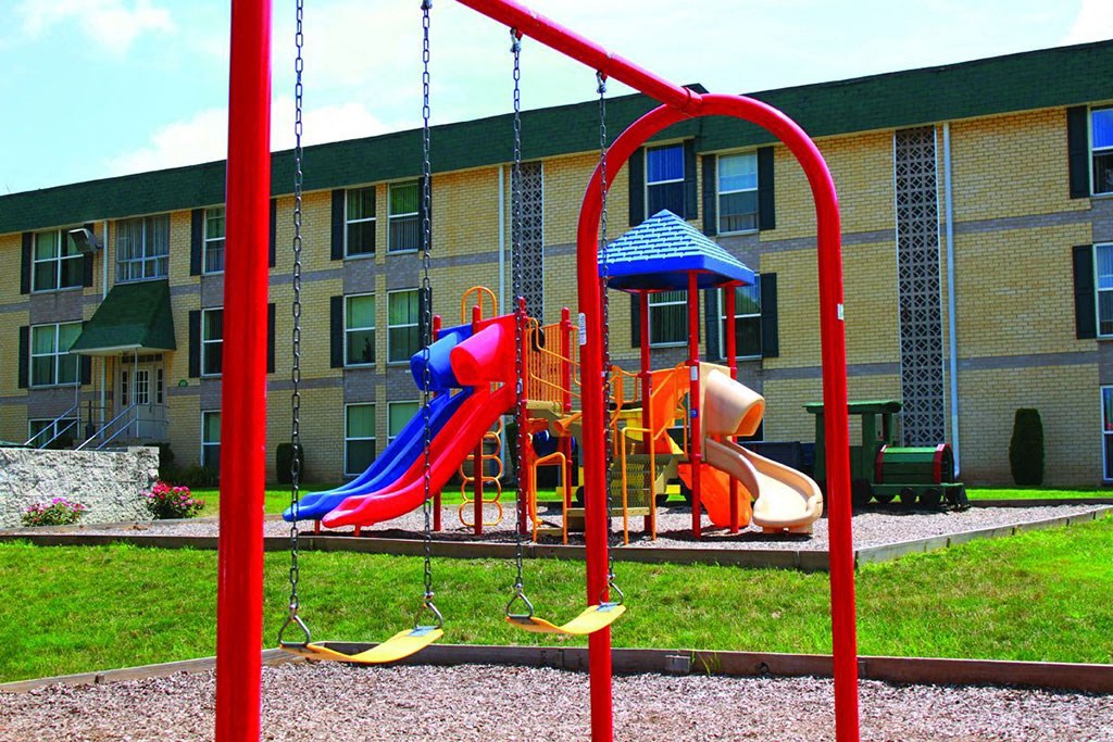 a playground in front of an apartment building