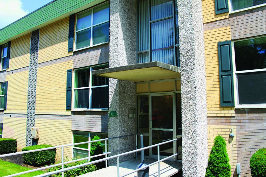 the front of a building with a ramp and stairs