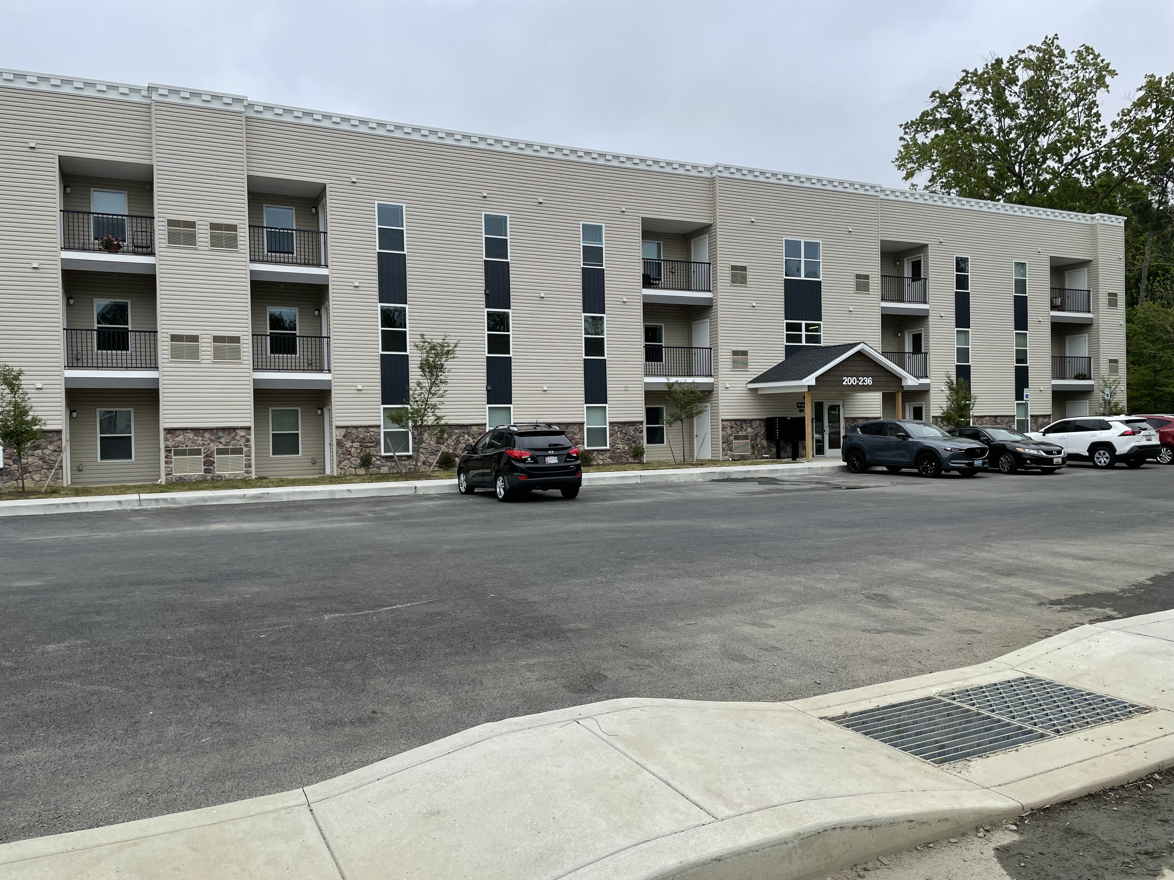 an apartment building with cars parked in front of it