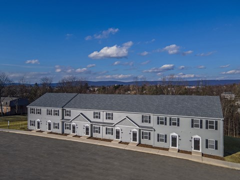 A large grey building with a grey roof and white trim.