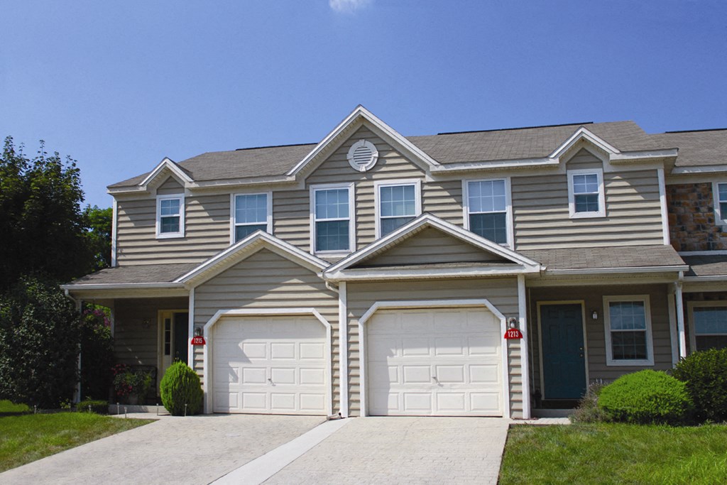a tan and with two garage doors