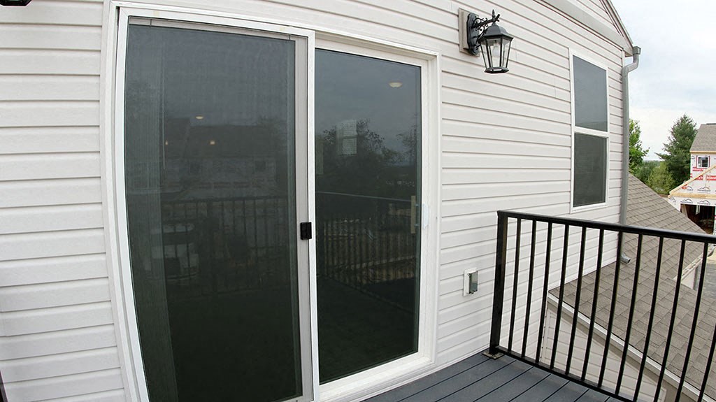 a sliding glass door on the side of a house