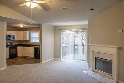 A living room with a fireplace and sliding glass doors.