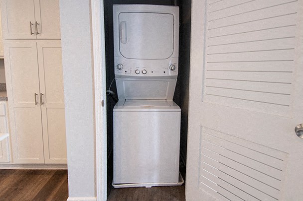 a refrigerator and a washing machine in a small room