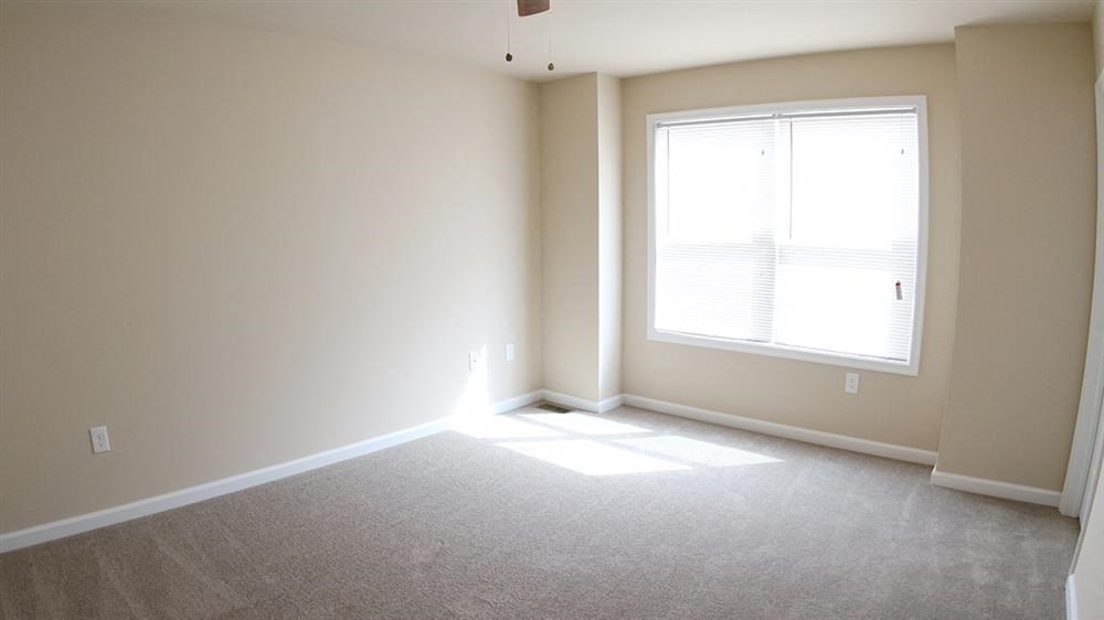 an empty living room with a large window