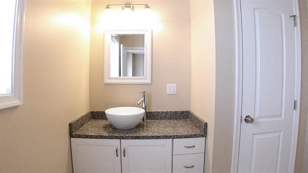 a bathroom with a sink and a mirror
