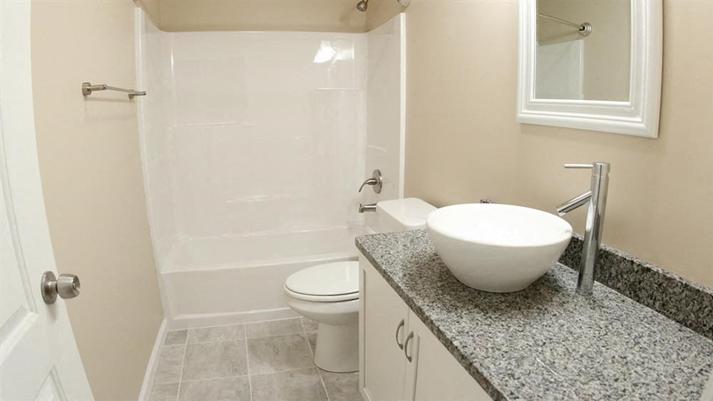 a bathroom with a sink and a toilet and a shower