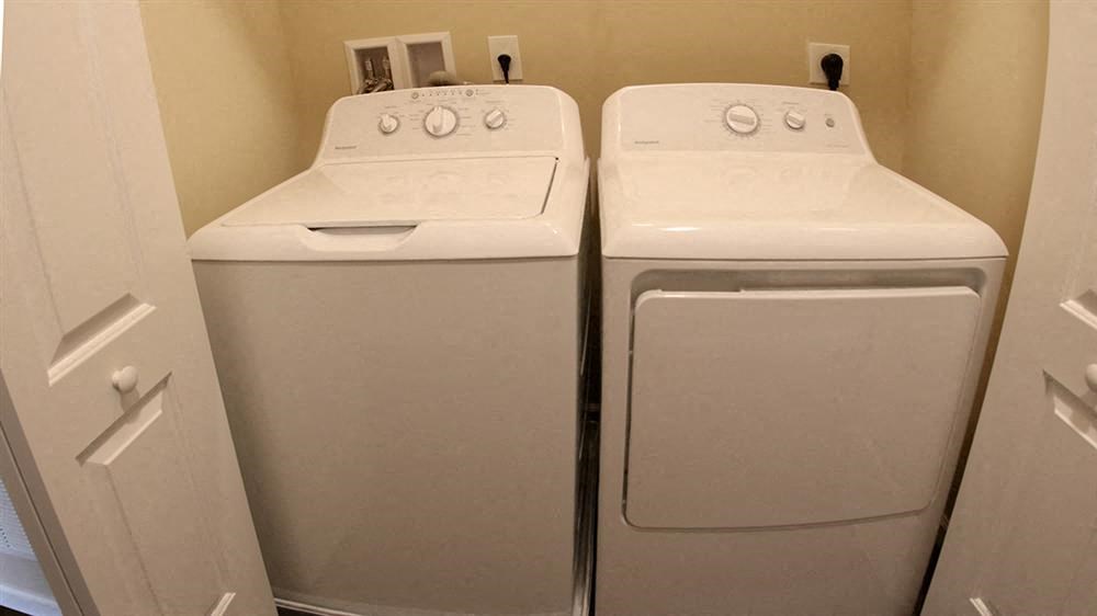 two white washing machines are next to each other