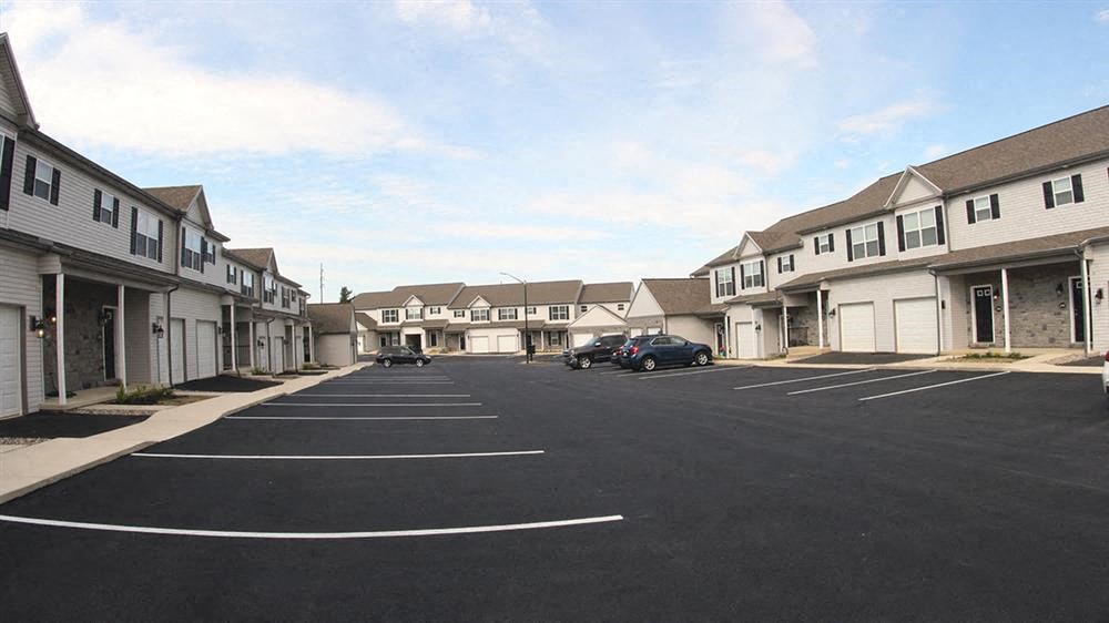 a parking lot in front of a row of houses