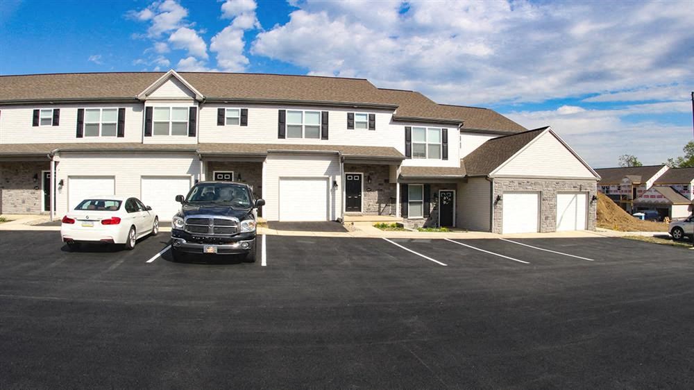 a car parked in a parking lot in front of a house