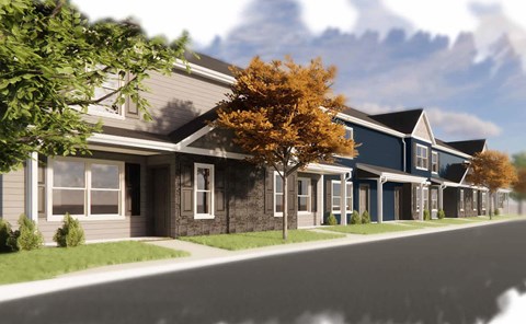A row of houses with a tree in front of the first one.