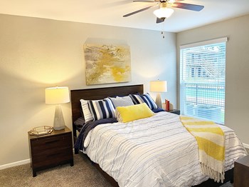 Large bedrooms with carpeting featuring walk-in closets at The Life at Forest View, Texas, 77531 - Photo Gallery 8