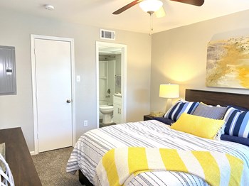 Large bedrooms with carpeting featuring walk-in closets at The Life at Forest View, Clute, 77531 - Photo Gallery 9