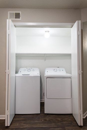 a small laundry room with two washers and a dryer - Photo Gallery 9