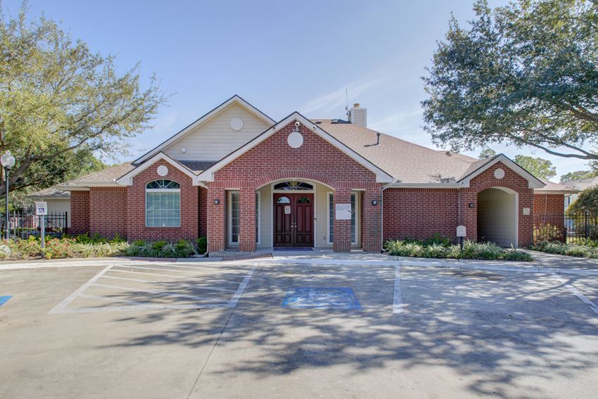 a large brick building with a driveway in front of it - Photo Gallery