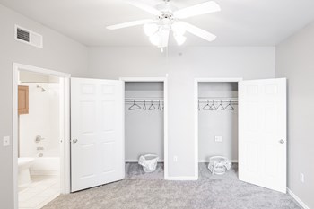 a bedroom with two closets and a ceiling fan - Photo Gallery 6