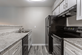 Modern kitchen with hardwood-style flooring Modern kitchen with hardwood-style flooring at The Life at Forest View, Clute - Photo Gallery 2