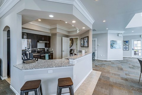 A kitchen with a bar area and a dining area at Abbey Ridge Apartment Homes, Michigan, 48371